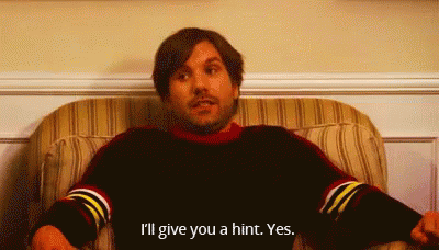A Man Is Sitting In A Chair And Saying I 'Ll Give You A Hint . GIF