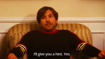 A Man Is Sitting In A Chair And Saying I 'Ll Give You A Hint Yes . GIF