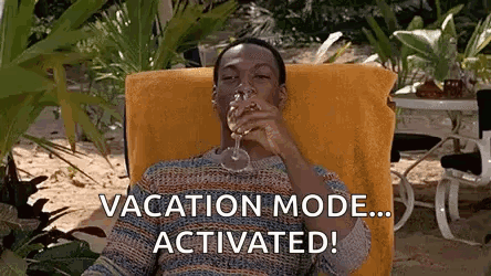 a man is sitting in a chair drinking a glass of wine and says `` vacation mode ... activated ! ''