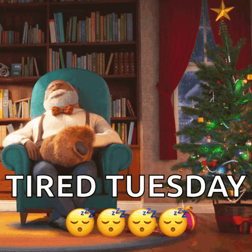 A Man Is Sitting In A Chair In Front Of A Christmas Tree With The Words " Tired Tuesday " On The Bottom GIF
