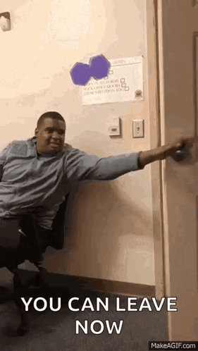 A Man Is Sitting In A Chair In Front Of A Door And Says You Can Leave Now GIF