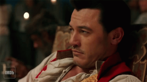 A Man Is Sitting In A Chair With A Imdb Logo In The Corner GIF
