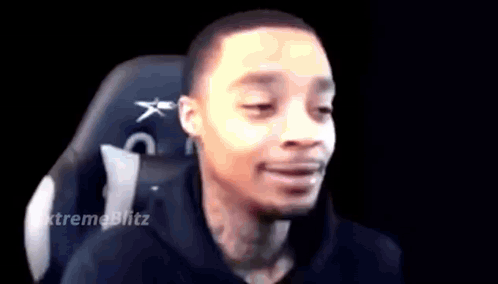 A Man Is Sitting In A Chair With His Eyes Closed . GIF