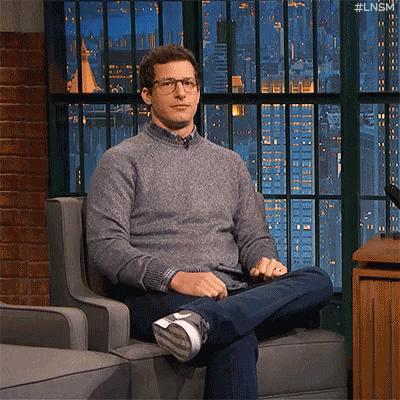 a man is sitting in a chair with his legs crossed and his feet up .