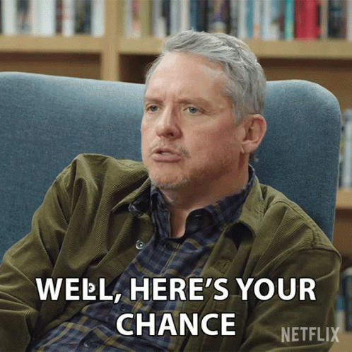 A Man Is Sitting In A Chair With The Words Well Here 'S Your Chance GIF