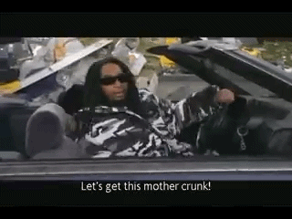 A Man Is Sitting In A Convertible Car Talking To Someone . GIF