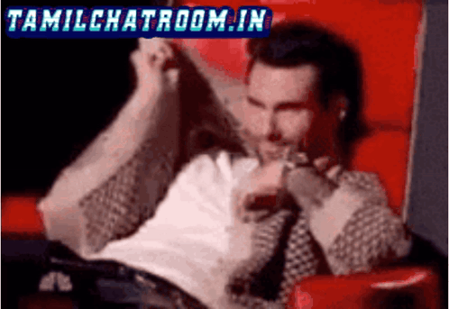 A Man Is Sitting In A Red Chair With The Words Tamilchatroom.in In The Corner GIF