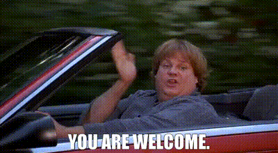 A Man Is Sitting In A Red Convertible Car And Waving . GIF