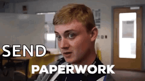 A Man Is Sitting In A Room With The Words Send Paperwork Written On The Screen . GIF