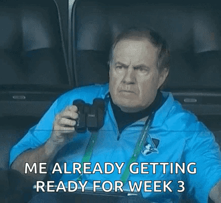 a man is sitting in a stadium holding a camera and says `` me already getting ready for week 3 ''