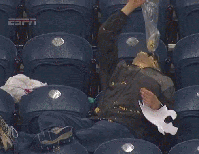 a man is sitting in a stadium with his face covered in popcorn and a piece of paper ..
