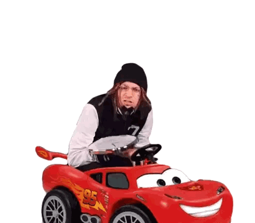 a man is sitting in a toy car that says lightning mcqueen