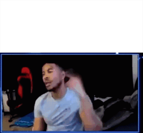 A Man Is Sitting In Front Of A Computer Screen . GIF