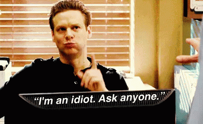 A Man Is Sitting In Front Of A Computer Screen That Says " I 'M An Idiot Ask Anyone " . GIF