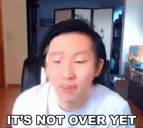 A Man Is Sitting In Front Of A Computer Screen With The Words `` It 'S Not Over Yet '' Written On The Screen . GIF