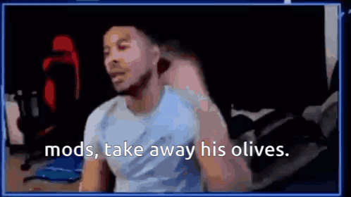 A Man Is Sitting In Front Of A Computer Screen With The Words `` Mods , Take Away His Olives '' Written On It . GIF