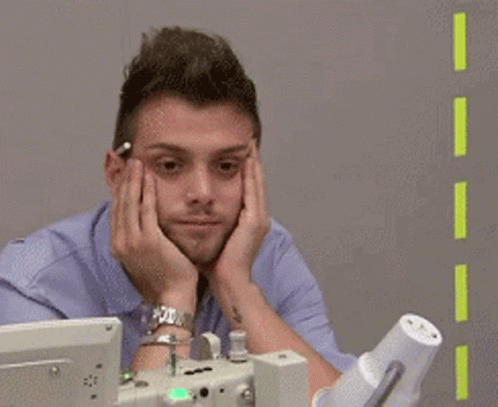 Man Sitting In Front Of Computer With Hands On Face GIF
