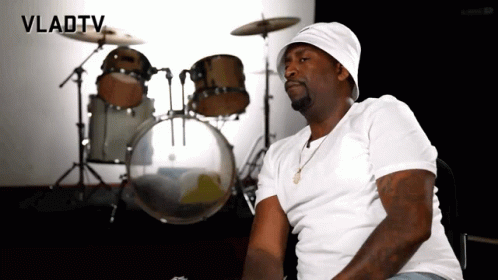 A Man Is Sitting In Front Of A Drum Set With Vladtv Written On The Bottom GIF