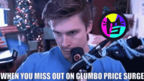 A Man Is Sitting In Front Of A Microphone With The Words When You Miss Out On Gumbo Price Surge Written Above Him GIF