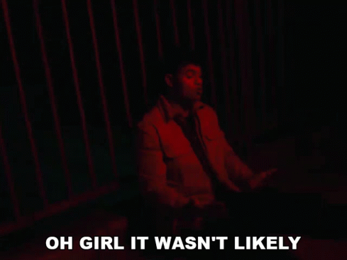 a man is sitting in front of a red fence with the words oh girl it wasn 't likely below him