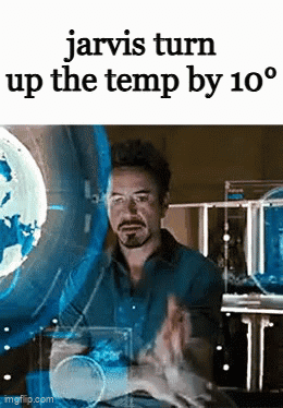 A Man Is Sitting In Front Of A Screen With The Words Jarvis Turn Up The Temp By 10 Degrees On It . GIF