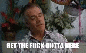 A Man Is Sitting In Front Of A Window With Balloons And Flowers In A Room . GIF