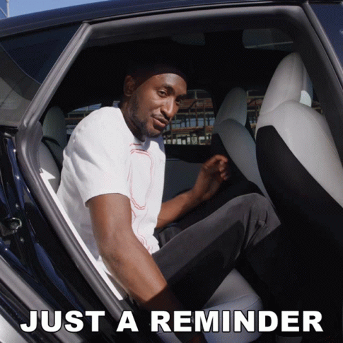 A Man Is Sitting In The Back Seat Of A Car And The Words Just A Reminder Are Above Him GIF