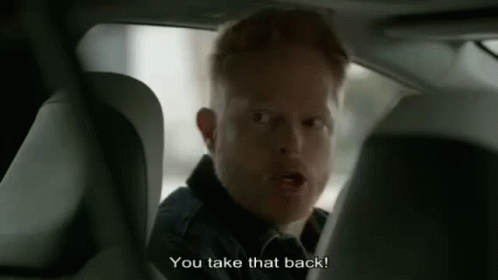 A Man Is Sitting In The Back Seat Of A Car Talking To Another Man . GIF