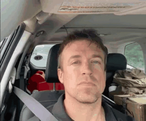 a man is sitting in the back seat of a car with a sticker on the roof that says wy