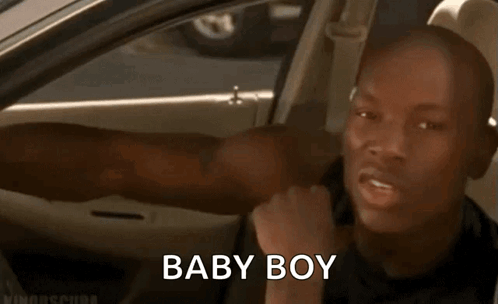 A Man Is Sitting In The Back Seat Of A Car With His Tongue Out And The Words Baby Boy Written On The Screen . GIF