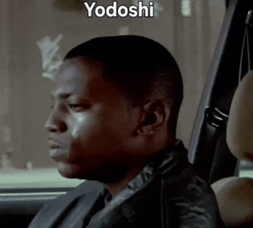 A Man Is Sitting In The Back Seat Of A Car With Yodoshi Written On The Bottom GIF