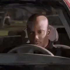 A Man Is Sitting In The Driver 'S Seat Of A Car . GIF