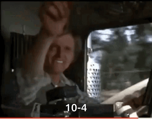 A Man Is Sitting In The Driver 'S Seat Of A Truck And Making A Face . GIF