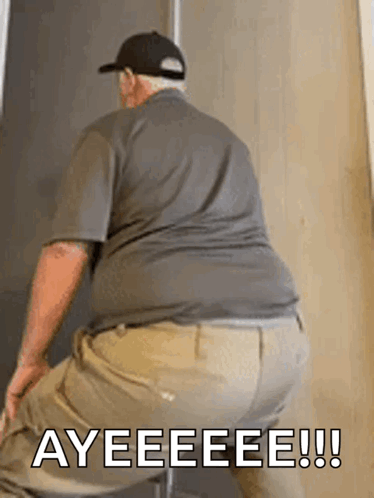 A Man Is Sitting On A Chair With The Words Ayeeeee Written On The Bottom Of His Butt . GIF
