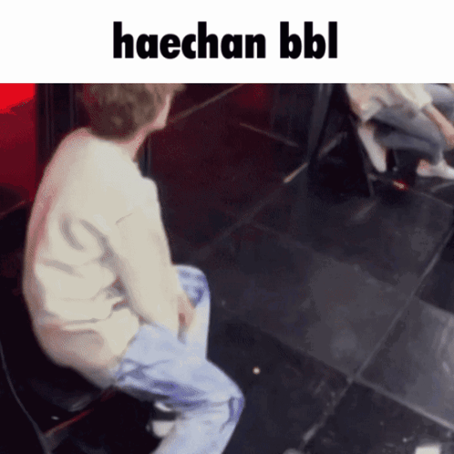 A Man Is Sitting On A Chair With The Words Haechan Bbl Written Above Him GIF