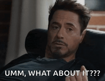 A Man Is Sitting On A Couch And Making A Funny Face While Talking About Something . GIF