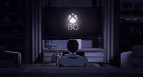 A Man Is Sitting On A Couch Watching A Video Game On A Television GIF
