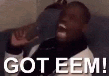 A Man Is Sitting On A Couch With His Mouth Open And Says `` Got Eem '' . GIF