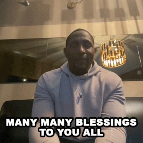 A Man Is Sitting On A Couch With The Words Many Many Blessings To You All GIF