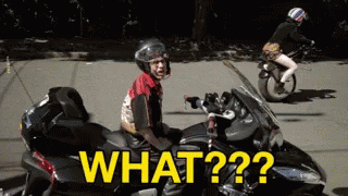 A Man Is Sitting On A Motorcycle With The Words What On The Side GIF