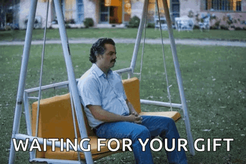 A Man Is Sitting On A Swing With The Words " Waiting For Your Gift " Below Him GIF