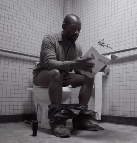 A Man Is Sitting On A Toilet Reading A Book Titled " A Man 'S Manual " GIF