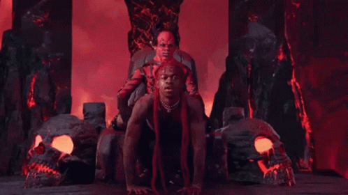 A Man Is Sitting On Top Of Another Man In A Throne In A Video . GIF