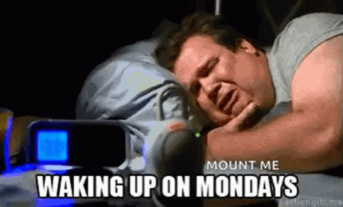 A Man Is Sleeping In A Bed With A Alarm Clock In The Background And The Words `` Mount Me Waking Up On Mondays '' . GIF