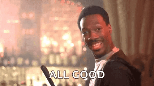 A Man Is Smiling And Holding A Bat And The Words `` All Good '' Are Written On The Screen . GIF