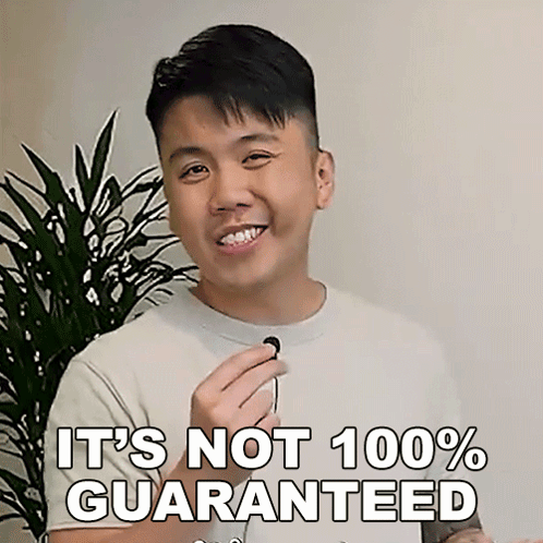 A Man Is Smiling And Holding A Microphone With The Words " It 'S Not 100 % Guaranteed " Next To Him GIF