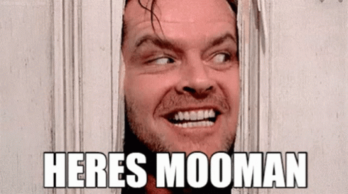 A Man Is Smiling And Looking Through A Hole In A Wall With The Words Heres Mooman Above Him . GIF