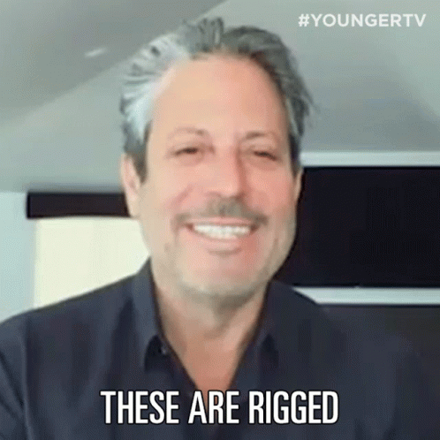 A Man Is Smiling And Saying `` These Are Rigged '' . GIF