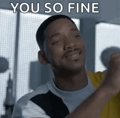 A Man Is Smiling And Saying `` You So Fine '' While Holding His Fist Up In The Air . GIF