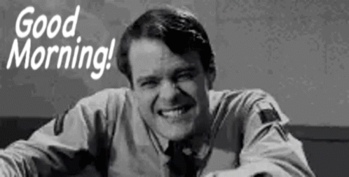 A Man Is Smiling In A Black And White Photo With The Words `` Good Morning '' . GIF